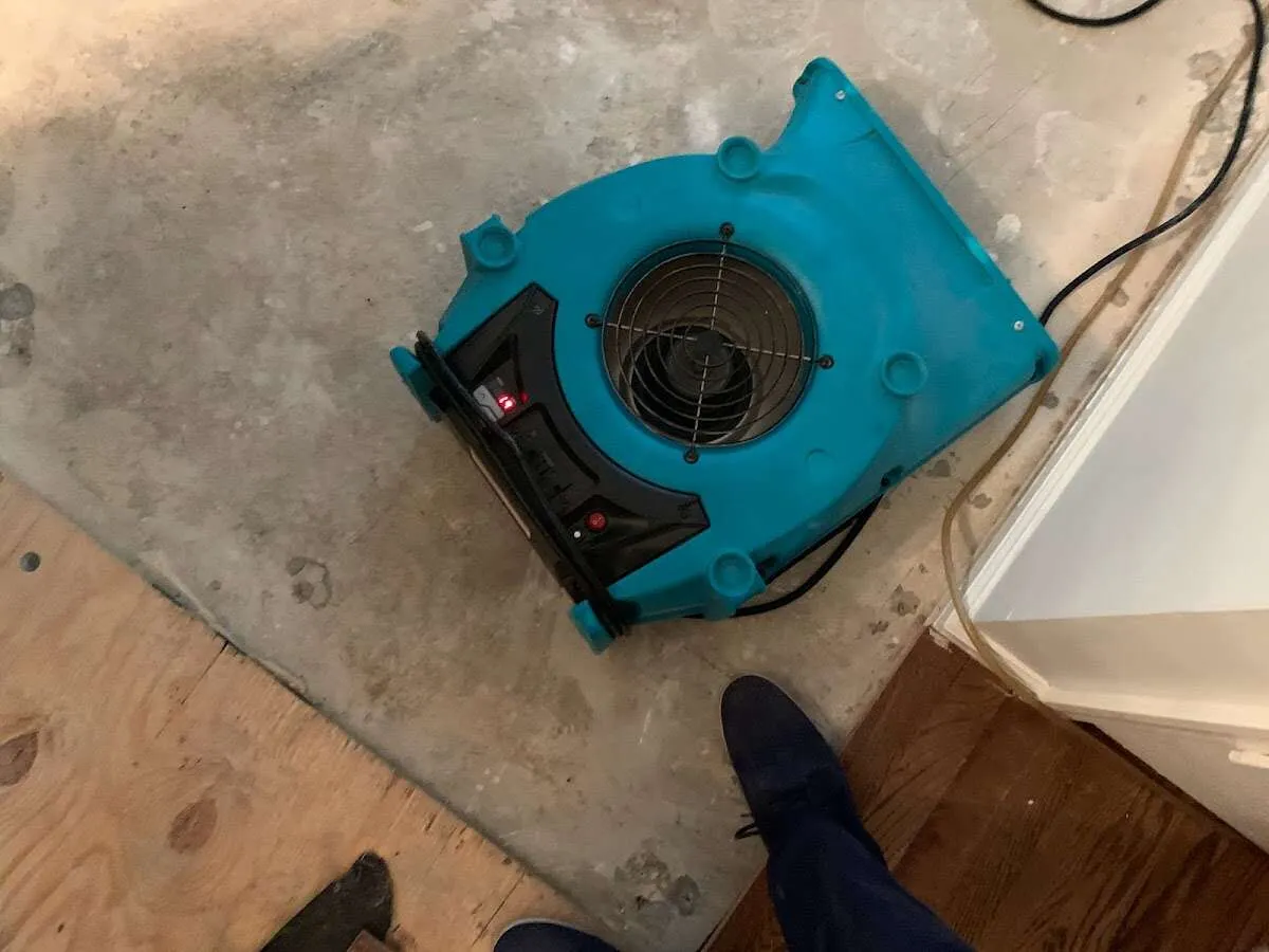 Air mover drying subfloor during Commercial Water Damage Restoration in Chamblee